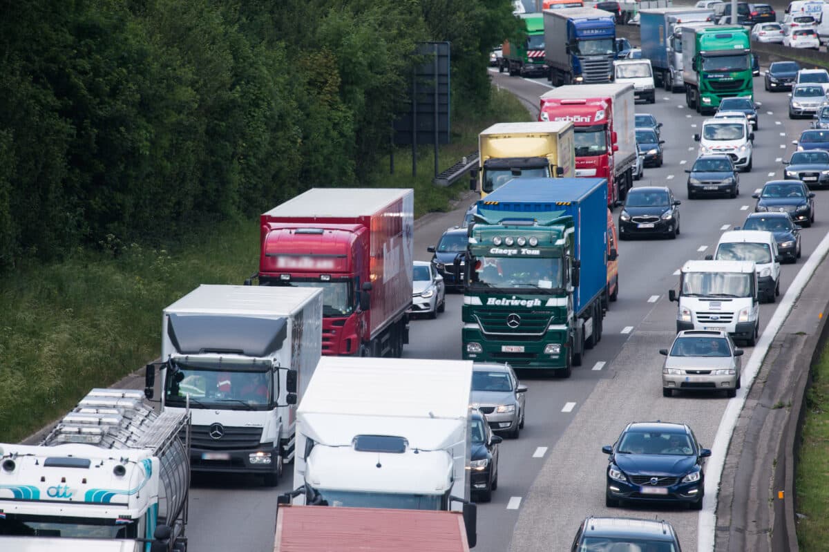 Busses, commercial vehicles, vans and lorries driving on a motorway
