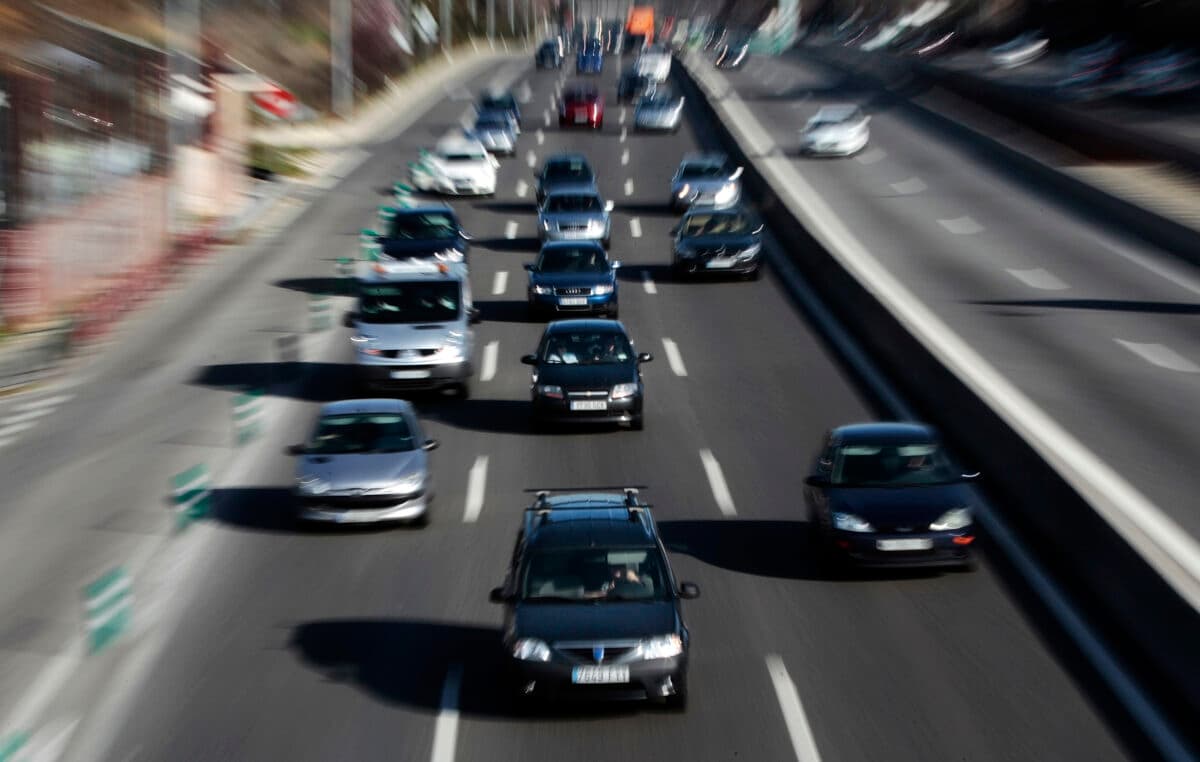 Cars drive away from Madrid on highway A-6